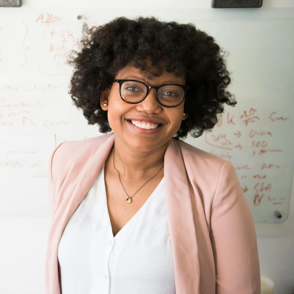 Woman in front of white board. Good Debt vs. Bad Debt
